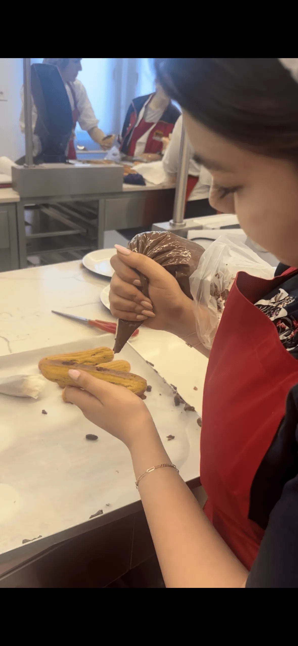 Piping dough at a baking workshop